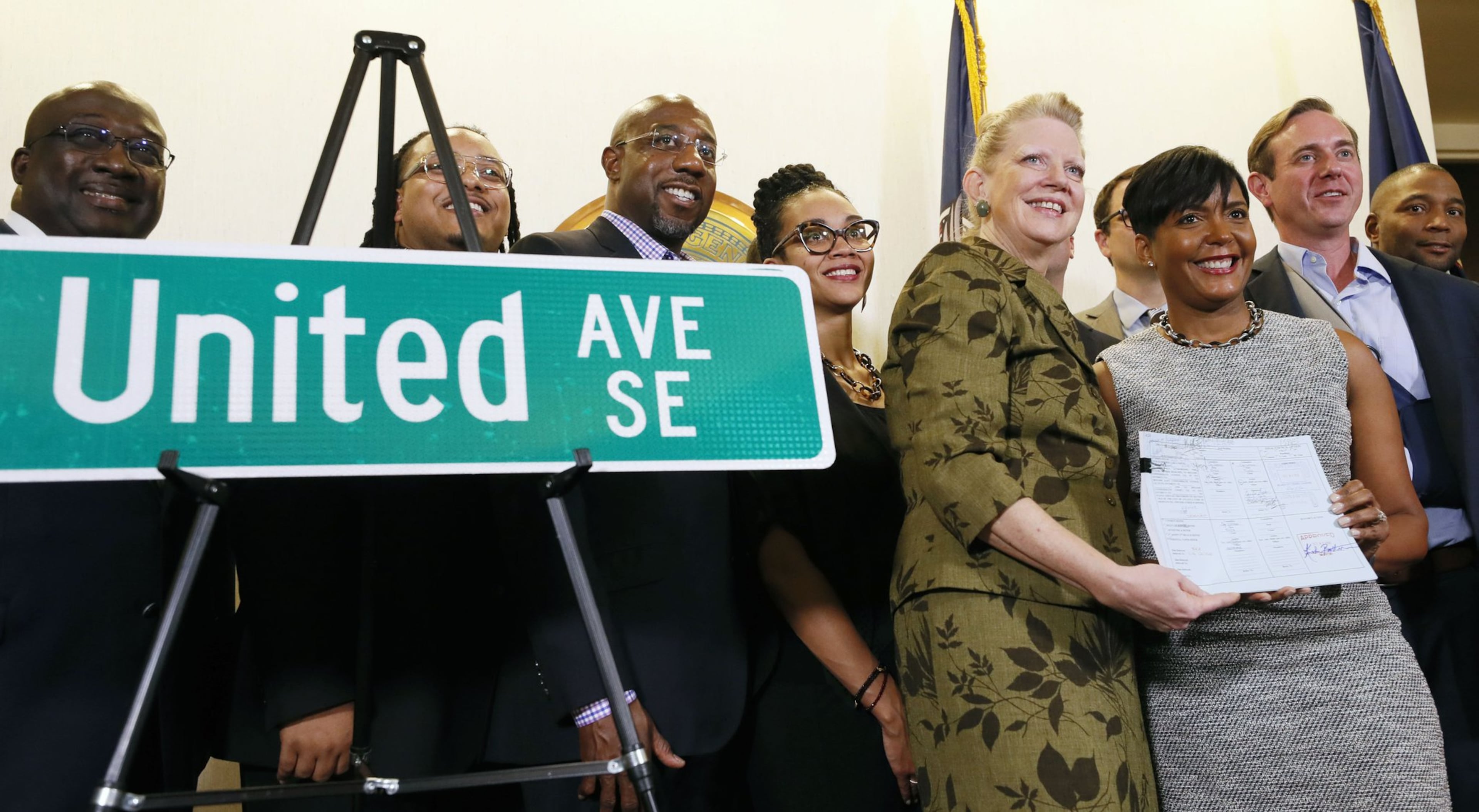 Then-Council member Carla Smith joins then-Mayor Keisha Lance Bottoms after she signed a bill changing the name of Confederate Avenue to United Avenue. (Bob Andres/AJC)