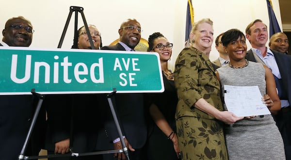 Then-Council member Carla Smith joins then-Mayor Keisha Lance Bottoms after she signed a bill changing the name of Confederate Avenue to United Avenue. (Bob Andres/AJC)