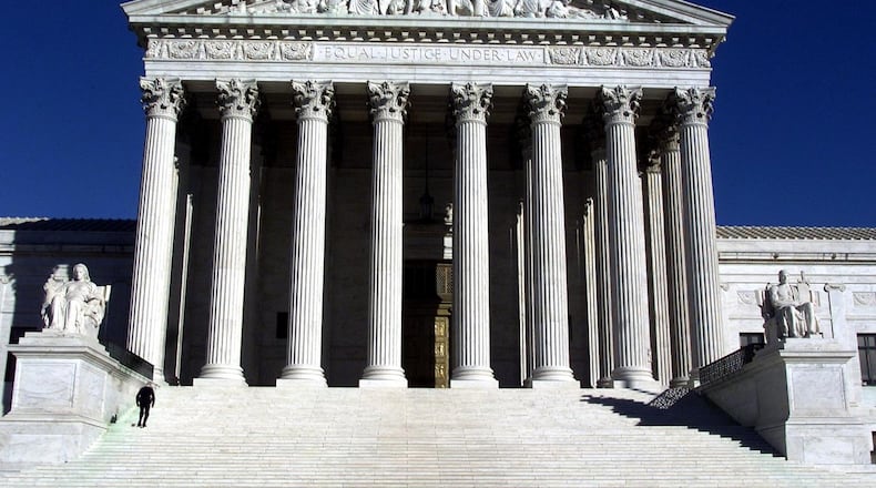 (NYT18) WASHINGTON -- Oct. 29, 2001 -- TERROR-ANTHRAX-COX -- A police officer walks up the steps of the closed U.S. Supreme Court building. (Rick McKay/Cox News Service)