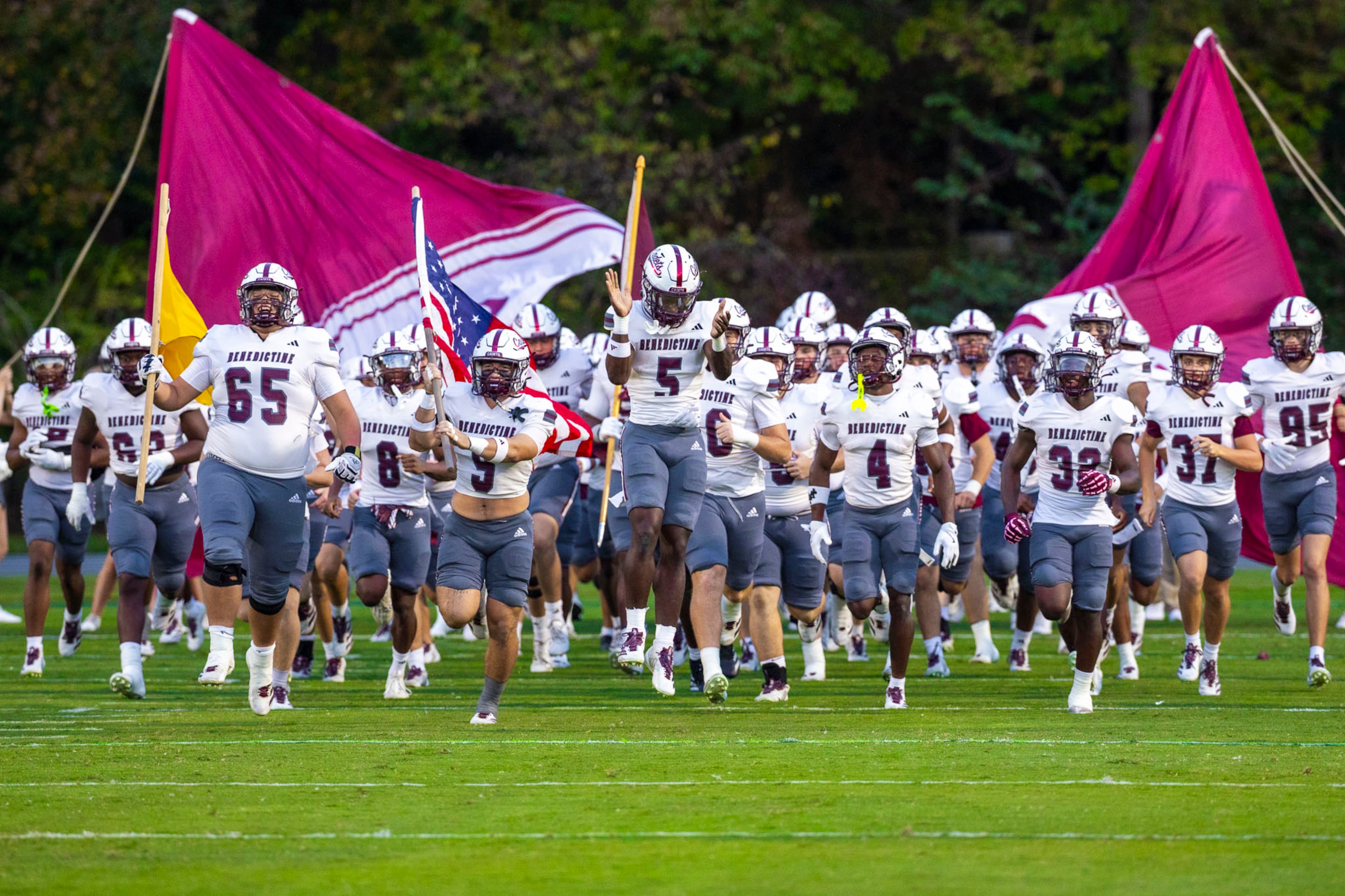 Benedictine players run through the banner before a game against Westminster at Fritz Orr Field in Atlanta, GA on Friday, Sept. 19th, 2025. (Oscar Guevara Saenz for the AJC)