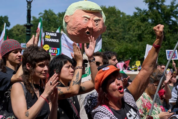 A puppet of U.S. President Donald Trump is held up during a demonstration ahead of the NATO summit in The Hague, Netherlands, Sunday, June 22, 2025. (AP Photo/Peter Dejong)