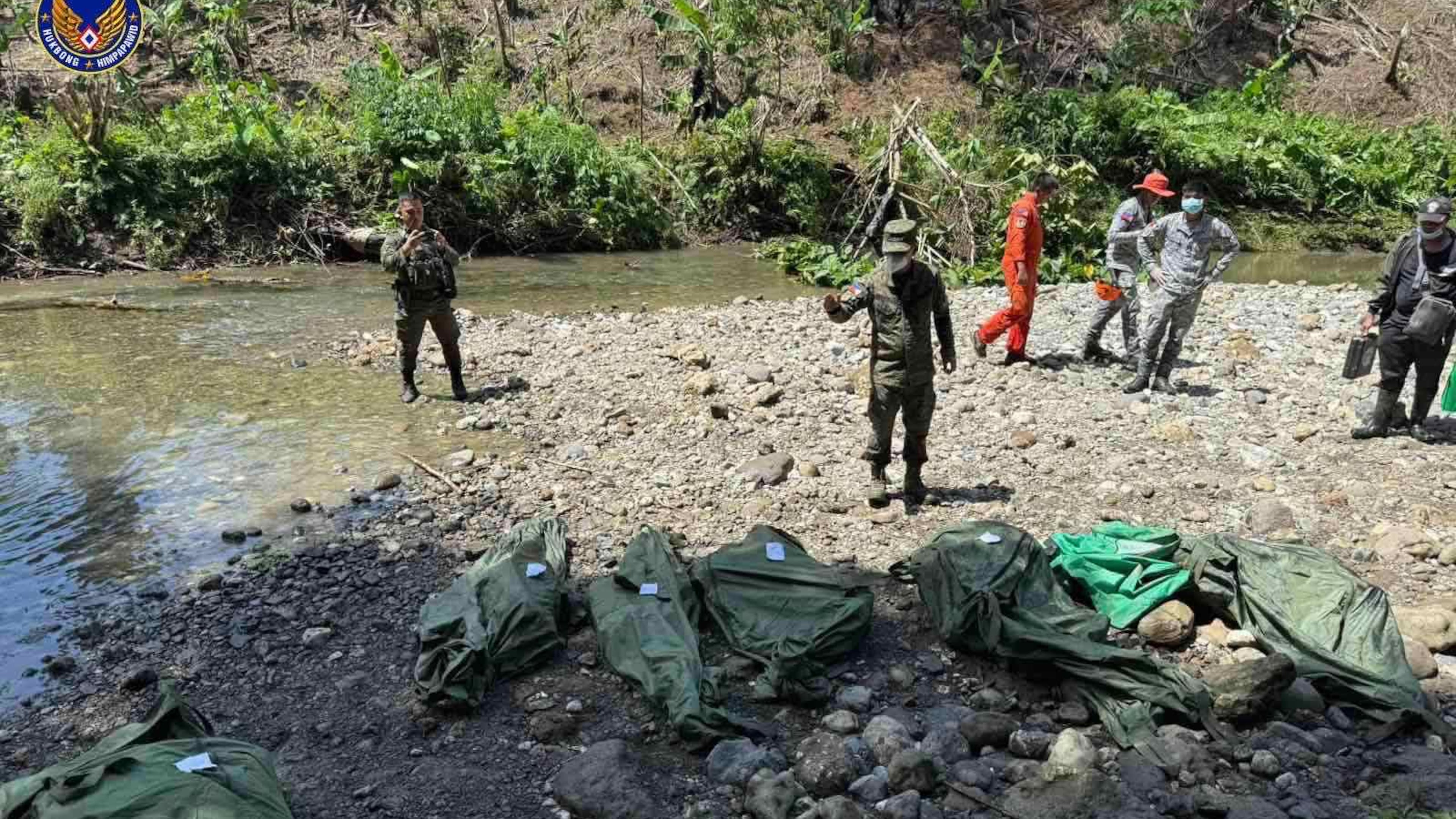 In this photo provided by the Philippine Air Force, Philippine Air Force personnel retrieve the remains of the pilots and crew of the Super Huey helicopter on Wednesday, Nov. 5, 2025, a day after it crashed in Agusan del Sur province, southern Philippines while on a humanitarian and disaster response mission due to Typhoon Kalmaegi. (Philippine Air Force via AP)