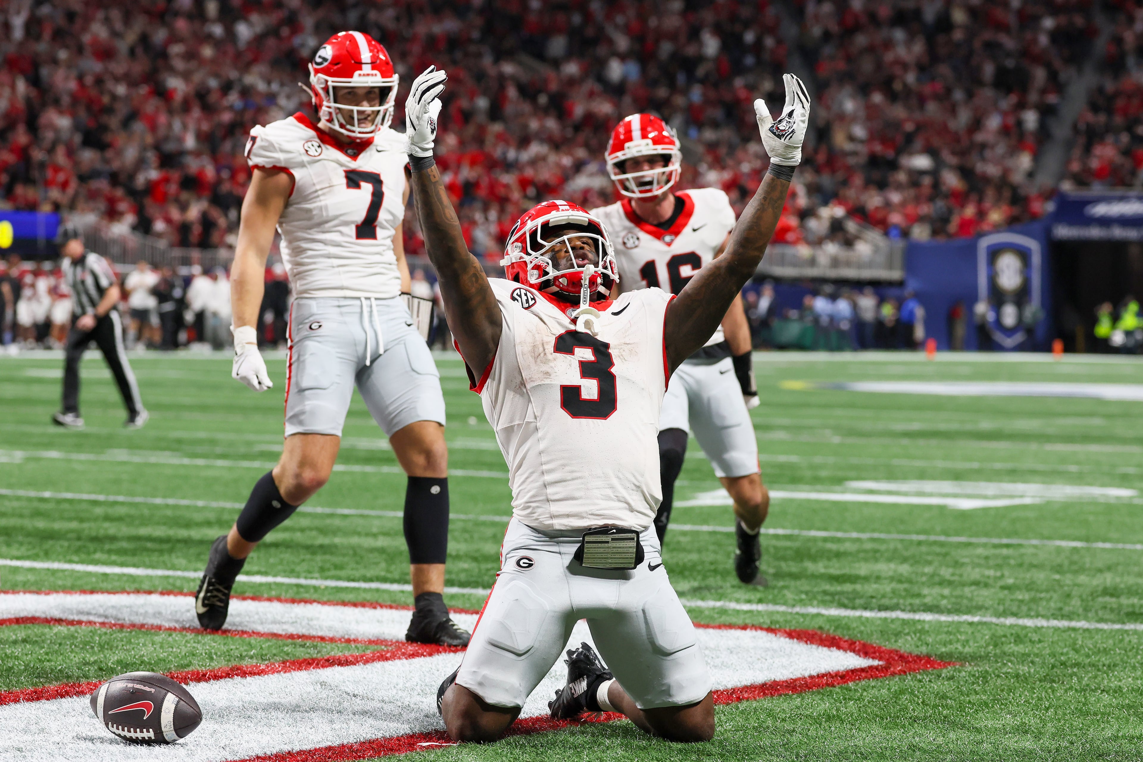 Georgia running back Nate Frazier (3) celebrates a nine yard touchdown run against Alabama with blocking help from tight end Lawson Luckie (7) and wide receiver London Humphreys (16) during the third quarter of the SEC Championship game at Mercedes-Benz Stadium, Saturday, Dec. 6, 2025, in Atlanta. (Jason Getz / AJC)