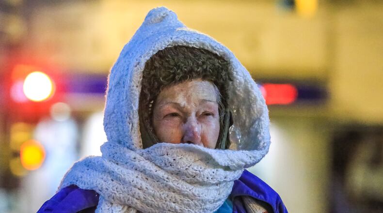 Glenn Gilley of Jonesboro walks through Five Points in Atlanta on a recent cold day. JOHN SPINK/JSPINK@AJC.COM