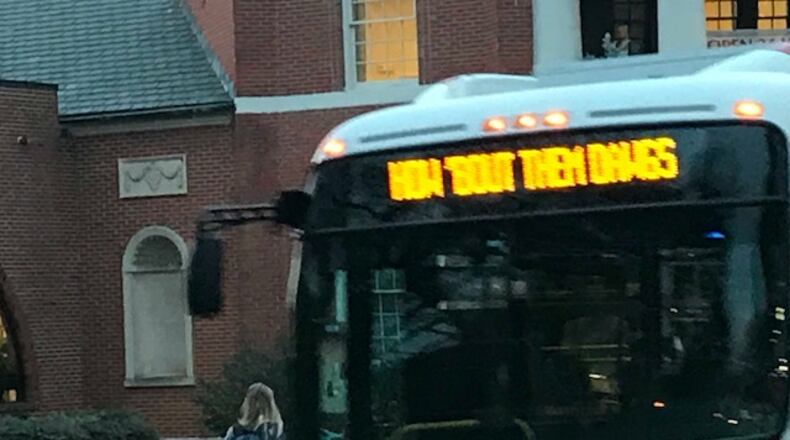 A University of Georgia walks toward a campus bus Tuesday morning that shares the feelings of many students, although they didn’t win. ERIC STIRGUS / ESTIRGUS@AJC.COM