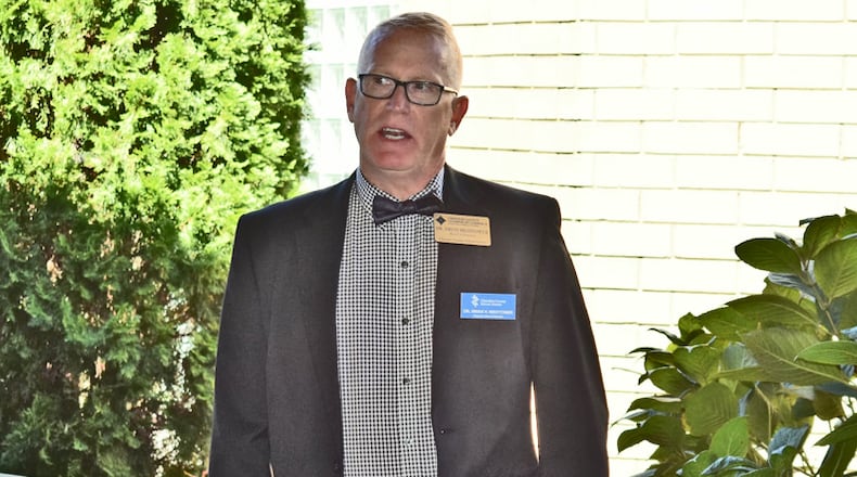 Cherokee County schools Superintendent Brian V. Hightower congratulates Mountain Ed Charter High School at an opening ceremony this fall. The county School Board has approved extending Hightower's contract through June, 2024.