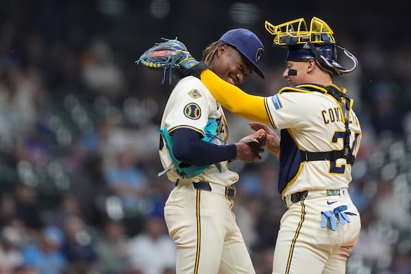 Milwaukee Brewers' Abner Uribe, left, laughs with William Contreras during a mound visit during the eighth inning of a baseball game against the Atlanta Braves, Tuesday, June 10, 2025, in Milwaukee. (AP Photo/Aaron Gash)