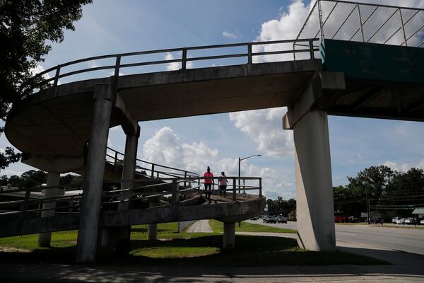 Nicole Green and Sharla Gorman walk down the ramp on an uncovered pedestrian crossing over Highway 21 in Garden City.