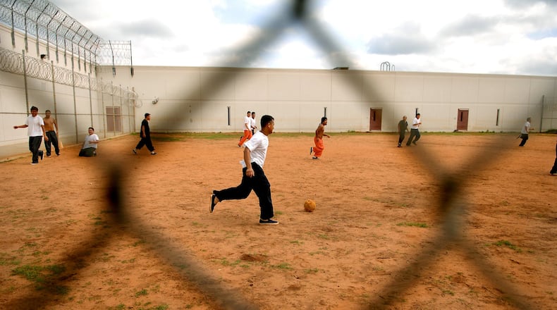 Detainees playing soccer at Stewart Detention Center, a holding facility for immigrants being processed for deportation. (JOEY IVANSCO/staff photo).