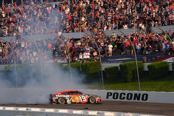 Chase Briscoe celebrates with a burnout after winning a NASCAR Cup Series auto race at Pocono Raceway, Sunday, June 22, 2025, in Long Pond, Pa. (AP Photo/Derik Hamilton)