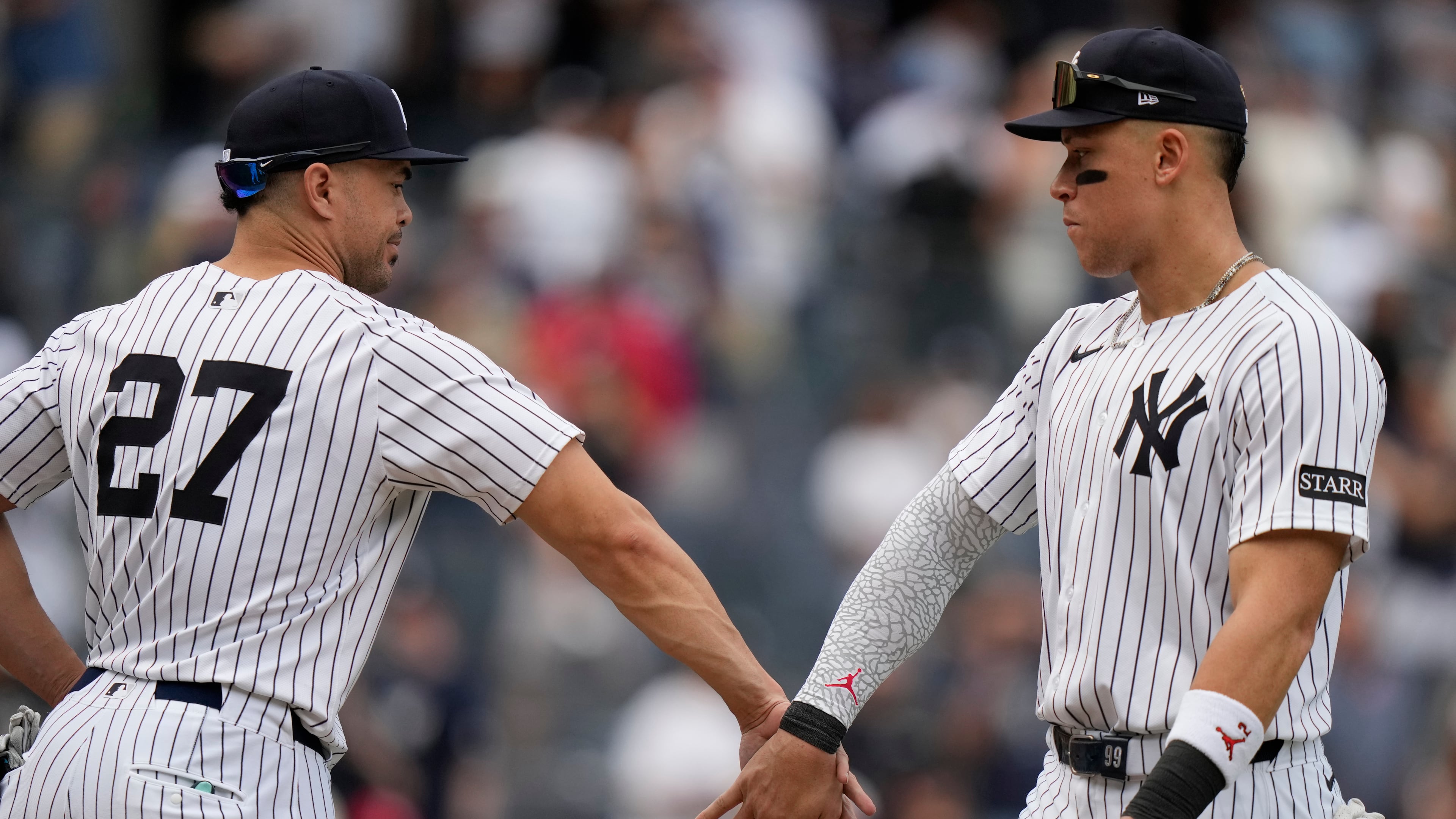 New York Yankees' Giancarlo Stanton, left, celebrates with Aaron Judge after a baseball game against the Baltimore Orioles Saturday, Sept. 27, 2025, in New York. (AP Photo/Frank Franklin II)