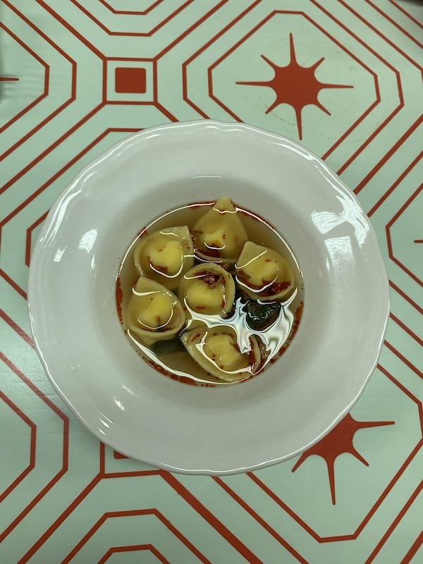 Pasta served in broth in a small bowl.