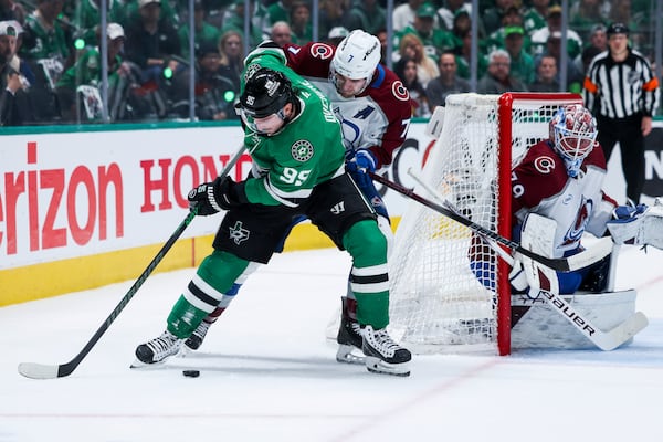 Dallas Stars center Matt Duchene (95) looks to shoot around Colorado Avalanche defenseman Devon Toews (7) during a first-round NHL hockey playoff game in Dallas, Saturday, April 19, 2025. (AP Photo/Gareth Patterson)