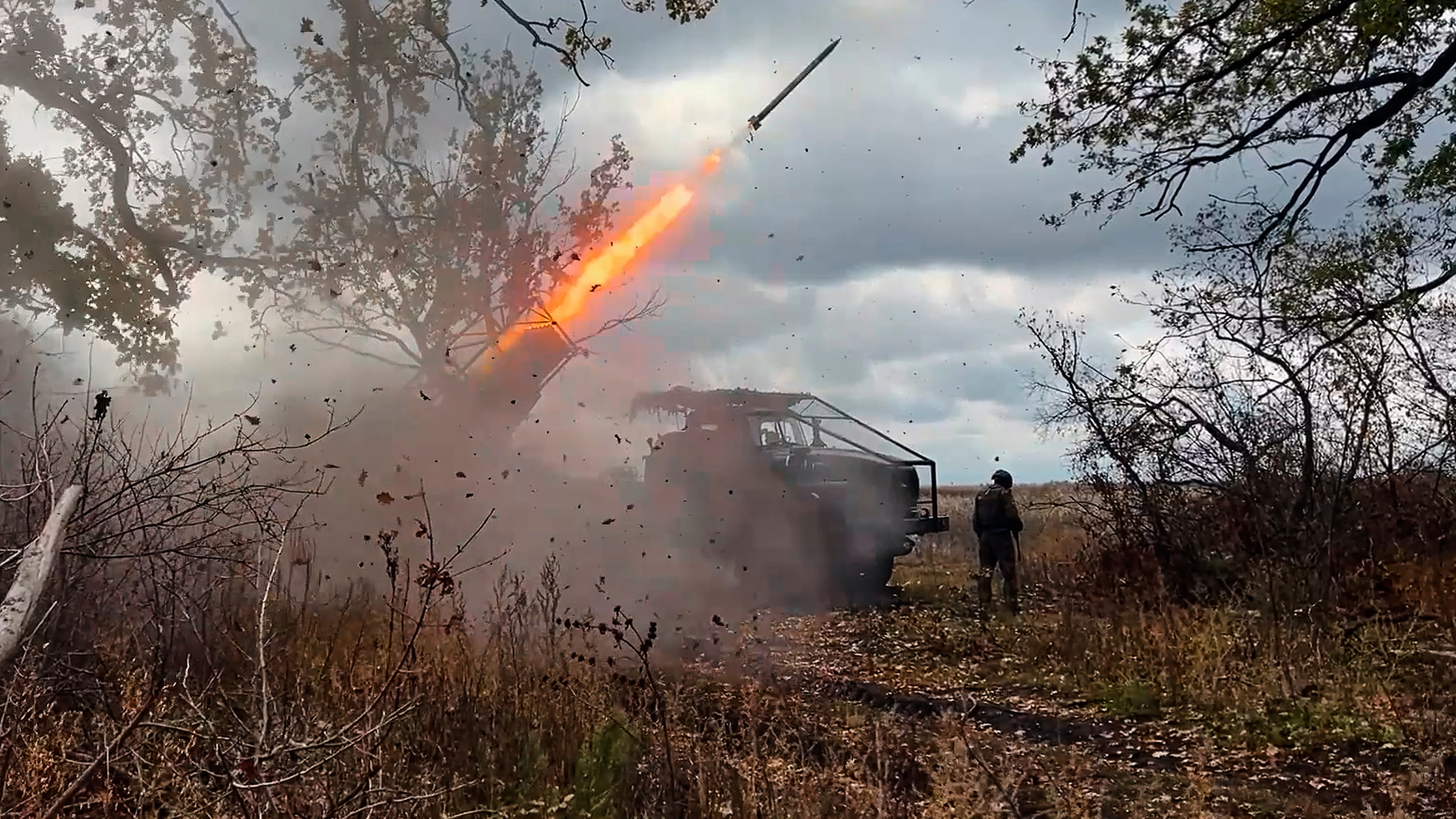 In this image made from video provided by the Russian Defense Ministry Press Service on Friday, Oct. 31, 2025, a Russian "Grad" self-propelled 122 mm multiple rocket launcher fires towards Ukrainian positions on an undisclosed location in Ukraine. (Russian Defense Ministry Press Service via AP)