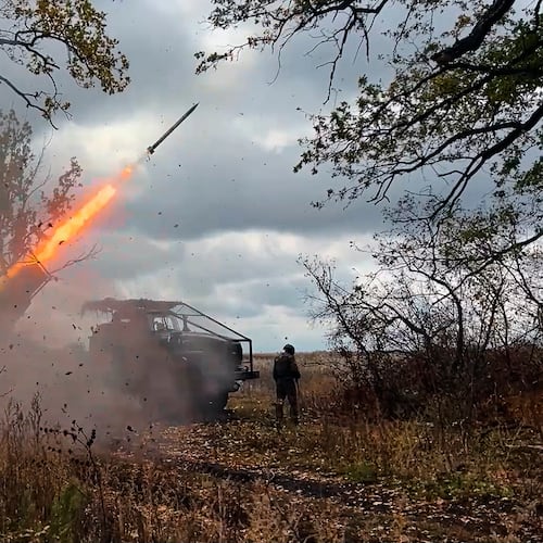 In this image made from video provided by the Russian Defense Ministry Press Service on Friday, Oct. 31, 2025, a Russian "Grad" self-propelled 122 mm multiple rocket launcher fires towards Ukrainian positions on an undisclosed location in Ukraine. (Russian Defense Ministry Press Service via AP)