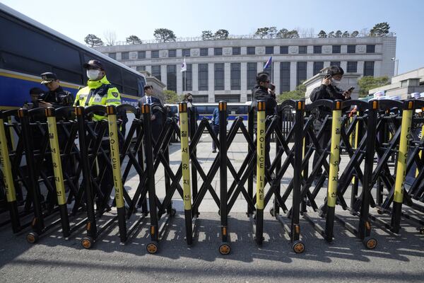 Police officers stand guard in front of the Constitutional Court in Seoul, South Korea, Tuesday, April 1, 2025. AP Photo/Ahn Young-joon)