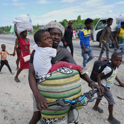 Residents flee their homes to escape clashes between armed gangs in Port-au-Prince, Haiti, Monday, May 11, 2026. (AP Photo/Odelyn Joseph)