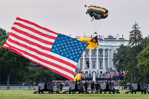 FILE - President Donald Trump and first lady Melania Trump watch as the U.S. Army Golden Knights Parachute Team descend during a "Salute to America" event on the South Lawn of the White House, July 4, 2020, in Washington. (AP Photo/Alex Brandon, File)