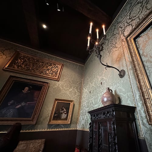 An empty frame hangs on patterned green walls in the Dutch Room at the Isabella Stewart Gardner Museum, where artworks were stolen in a 1990 art heist, April 9, 2026, in Boston. (AP Photo/Leah Willingham)