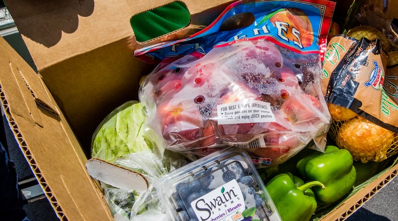 DeKalb County gave away bags of frozen chicken and boxes of fresh produce on May 22. (Jenni Girtman for Atlanta Journal Constitution)