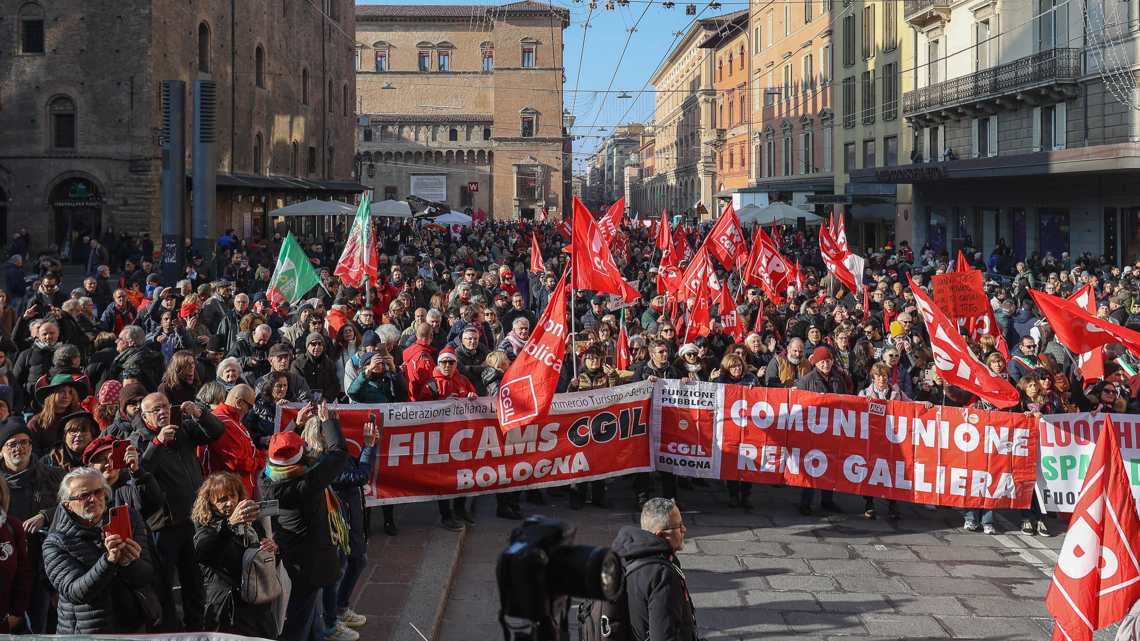 People gather on the occasion of a general strike called by the CGIL (Italian General Confederation of Labour) trade union to protest against the budget law in Bologna, Italy, Friday, Dec. 12, 2025. (Guido Calamosca/LaPresse via AP)
