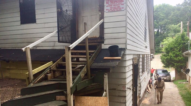 The stairs to the attic rooms at a rooming house at 575 Joseph E. Lowery Blvd. BILL TORPY / BTORPY@AJC.COM