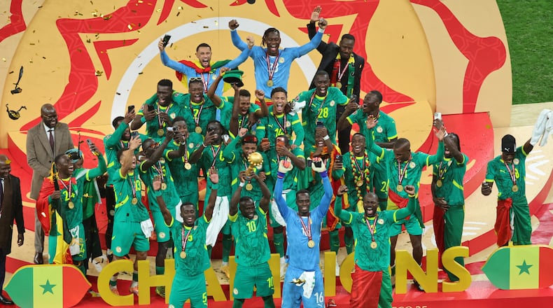 Senegal's Sadio Mane holds the trophy aloft as he celebrates with teammates after winning the Africa Cup of Nations final soccer match between Senegal and Morocco in Rabat, Morocco, Sunday, Jan. 18, 2026. (AP Photo/Youssef Loulidi)