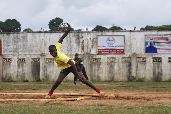 A kickball pitcher winds up before throwing a ball during a match at the Samuel Kanyon Doe Stadium in Monrovia, Liberia, June 14, 2025. (AP Photo/Annie Risemberg)
