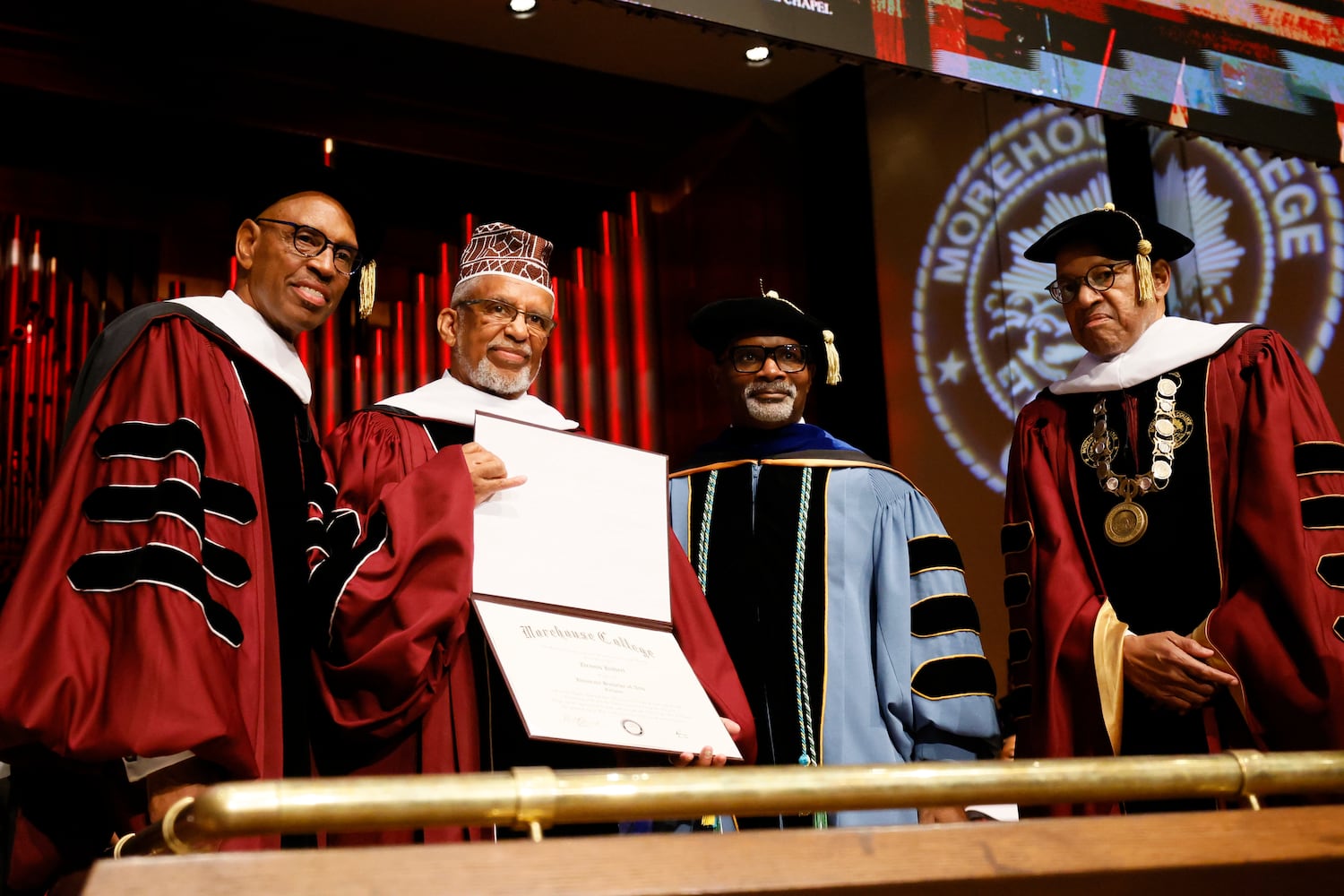  Iman Phelmon El-Amin (second from the left) receives an honorary degree from Morehouse College for his late uncle, Dennis T. Hubert, a Morehouse student who was lynched by a white mob in Atlanta's Pittsburgh neighborhood in 1930, during the 141st Commencement Ceremony of Morehouse College on Sunday, May 18, 2025.
(Miguel Martinez/ AJC)