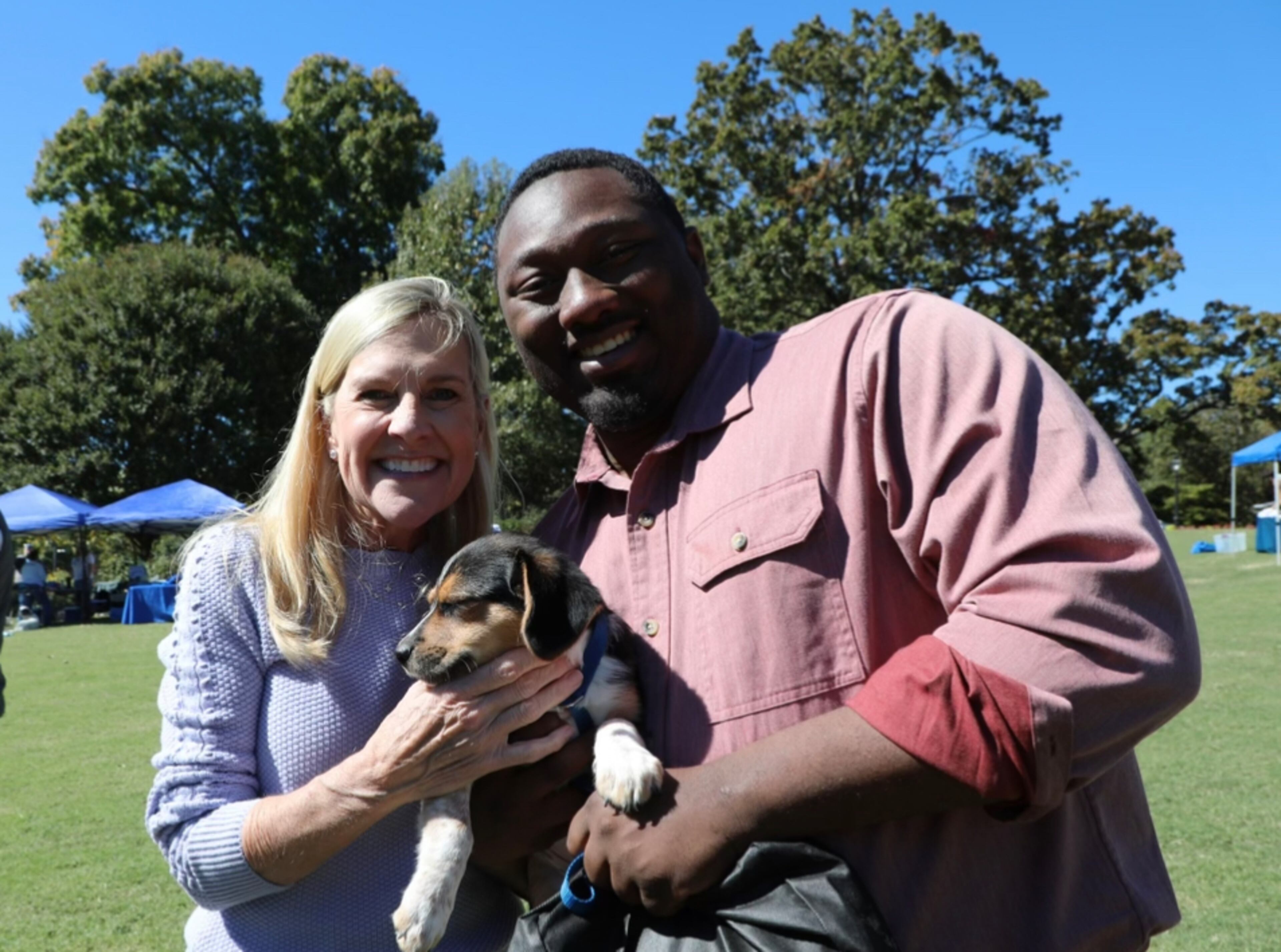 Garrison Douglas, who has been a spokesman for Gov. Brian Kemp, poses with his new dog at first lady Marty Kemp's Pet Adoption Day event in 2023.