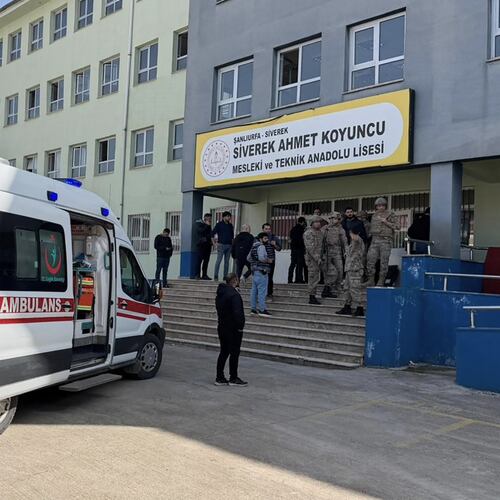 Turkish security forces and emergency staff stand at the courtyard of a high school where an assailant opened fire, in Siverek, south east Turkey, Tuesday, April 14, 2026, (Mevlut Bayraktar/IHA via AP)