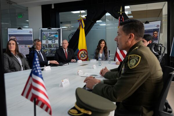 Homeland Security Secretary Kristi Noem, center, meets with the National Police's Counter Organized Crime Group at the Colombian National Police Directorate in Bogota, Columbia, Thursday, March 27, 2025. (AP Photo/Alex Brandon)
