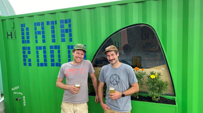 Halfway Crooks Beer owners and brewers Joran Van Ginderachter (left) and Shawn Bainbridge celebrate the opening of the newly renovated HC Biergarten.
(Bob Townsend for The Atlanta Journal-Constitution)