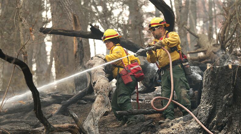 Firefighters Valerie Lopez and Mark Tabarez from southeast New Mexico put out hot spots at the Rock Mountain fire near Clayton. This year’s drought has contributed to a busy fire season. Typically, Georgia fights 30 wildfires a year, said Betty Jewett, who supervises the Chattahoochee-Oconee National Forest. This year, since October, 500 wildfires have spread across North Georgia. Curtis Compton/ccompton@ajc.com