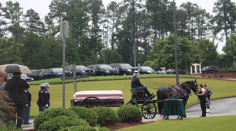 The flag-draped casket of Sgt. Christopher Monica departs funeral services in Milledgeville on Tuesday, June 20. J.D. CAPELOUTO/AJC