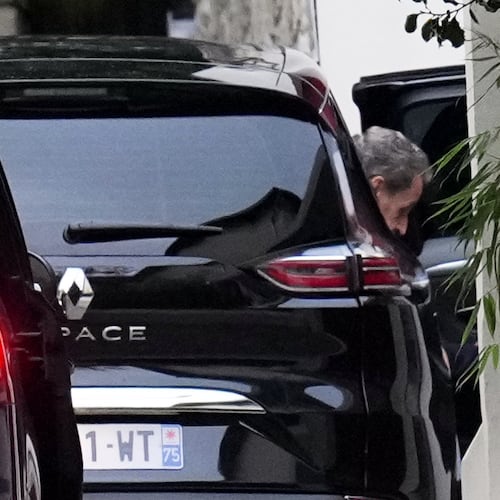 Former French President Nicolas Sarkozy leaves his car as he arrives at his home after being released from prison, Monday, Nov. 10, 2025 in Paris. (AP Photo/Christophe Ena)