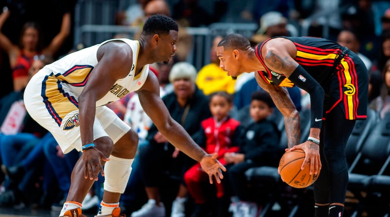 New Orleans Pelicans' Zion Williamson defends against Atlanta Hawks' Dejounte Murray during the first half of an NBA basketball game Saturday, Nov. 5, 2022, in Atlanta. (AP Photo/Hakim Wright Sr.)