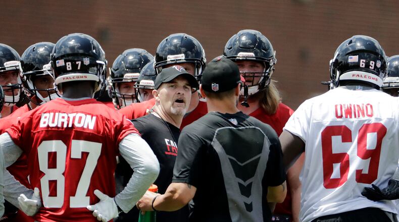 Atlanta Falcons head coach Dan Quinn talks with players during the team's NFL football rookie minicamp in Flowery Branch, Ga., Friday, May 12, 2017. (AP Photo/David Goldman)