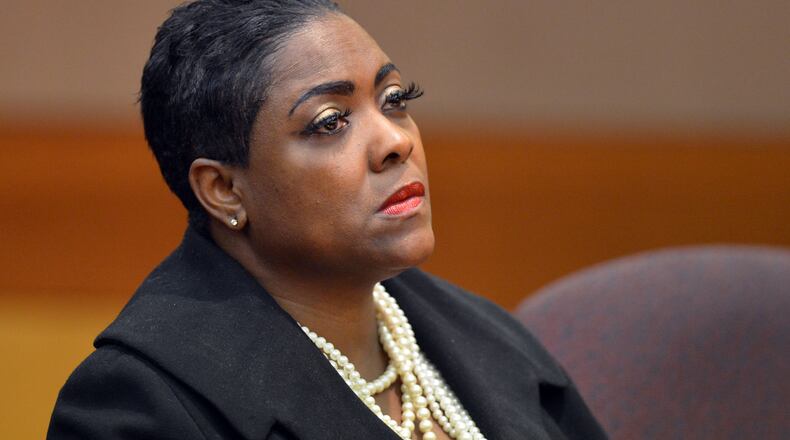 Lera Middlebrooks listens to her defense attorney Wesley Person during Wednesday's plea hearing. KENT D. JOHNSON / KDJOHNSON@AJC.COM