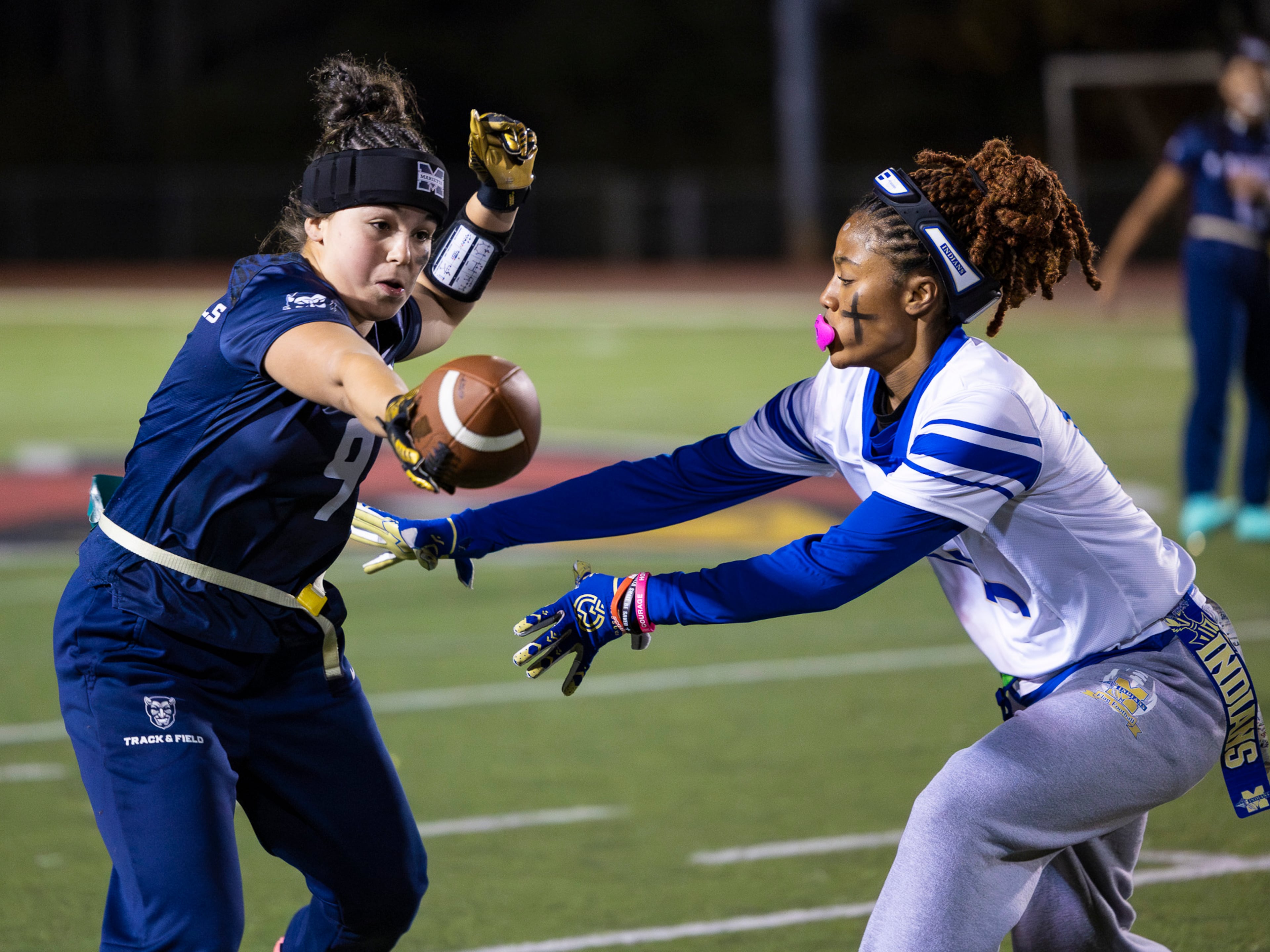 Marietta's Lylah Campos (9) dodges a flag grab in a flag football game against McEachern at Osborne High School in Marietta, GA on Monday, November 17th, 2025. (Oscar Guevara Saenz for the AJC)