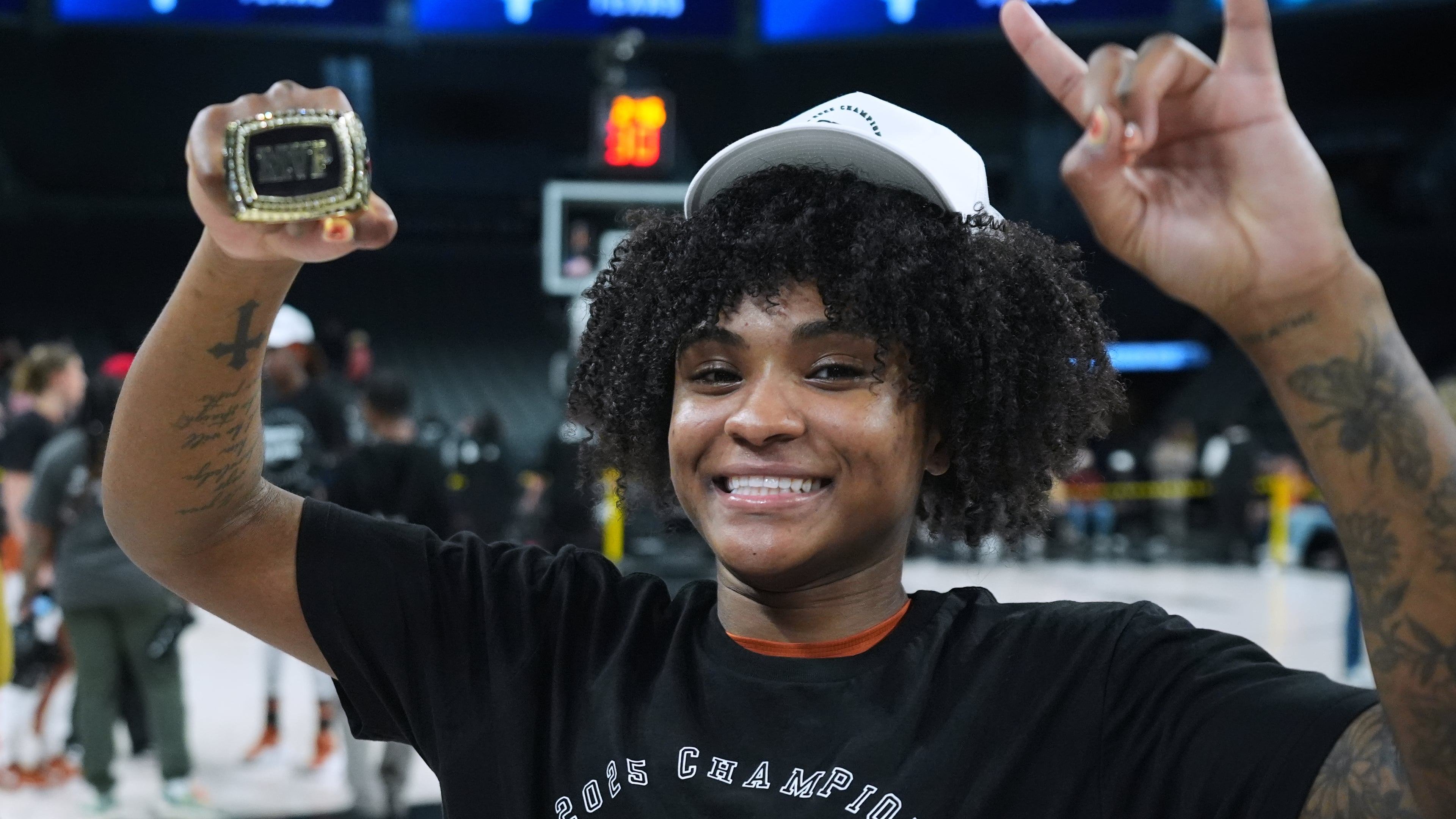 Texas guard Rori Harmon holds her MVP trophy as she and teammates celebrate their win over South Carolina in an NCAA college basketball game in the Players Era tournament in Las Vegas, Thursday, Nov. 27, 2025. (AP Photo/Eric Gay)