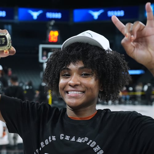 Texas guard Rori Harmon holds her MVP trophy as she and teammates celebrate their win over South Carolina in an NCAA college basketball game in the Players Era tournament in Las Vegas, Thursday, Nov. 27, 2025. (AP Photo/Eric Gay)