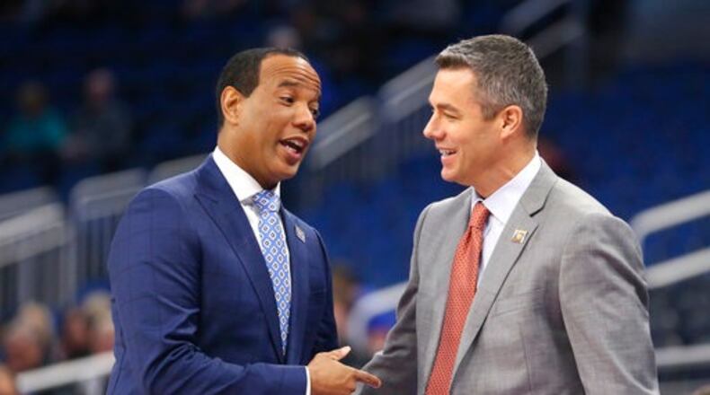 UNC Wilmington head coach Kevin Keatts, left, and Virginia head coach Tony Bennett greet each other before the start of a first-round men's college basketball game in the NCAA Tournament, Thursday, March 16, 2017, in Orlando, Fla. (AP Photo/Gary McCullough)