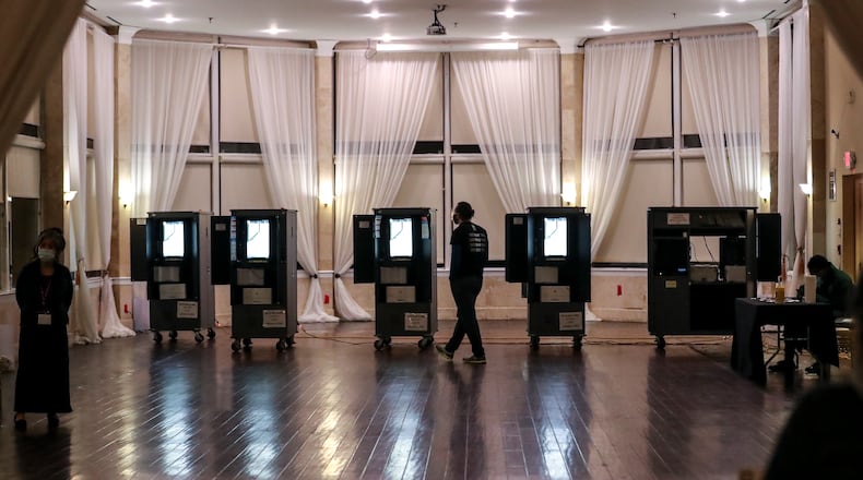January 5, 2021 Atlanta: A poll worker waits for the polls to open on Tuesday, Jan. 5, 2021 at the Park Tavern located at 500 10th St NE in Atlanta. Georgia’s long moment in the national spotlight culminated Tuesday, Jan. 5, 2021, when state voters cast their votes to determine which party would control the U.S. Senate. Georgia voters also voted to elect a member of the state Public Service Commission, which regulates energy and utility rates and issues. The two most expensive Senate races in history saw more than $833 million been spent by the four campaigns and outside groups supporting them, blanketing the airwaves and stuffing mailboxes across the state. Much of that money has come from organizations with no direct connection to Georgia. (John Spink / John.Spink@ajc.com)