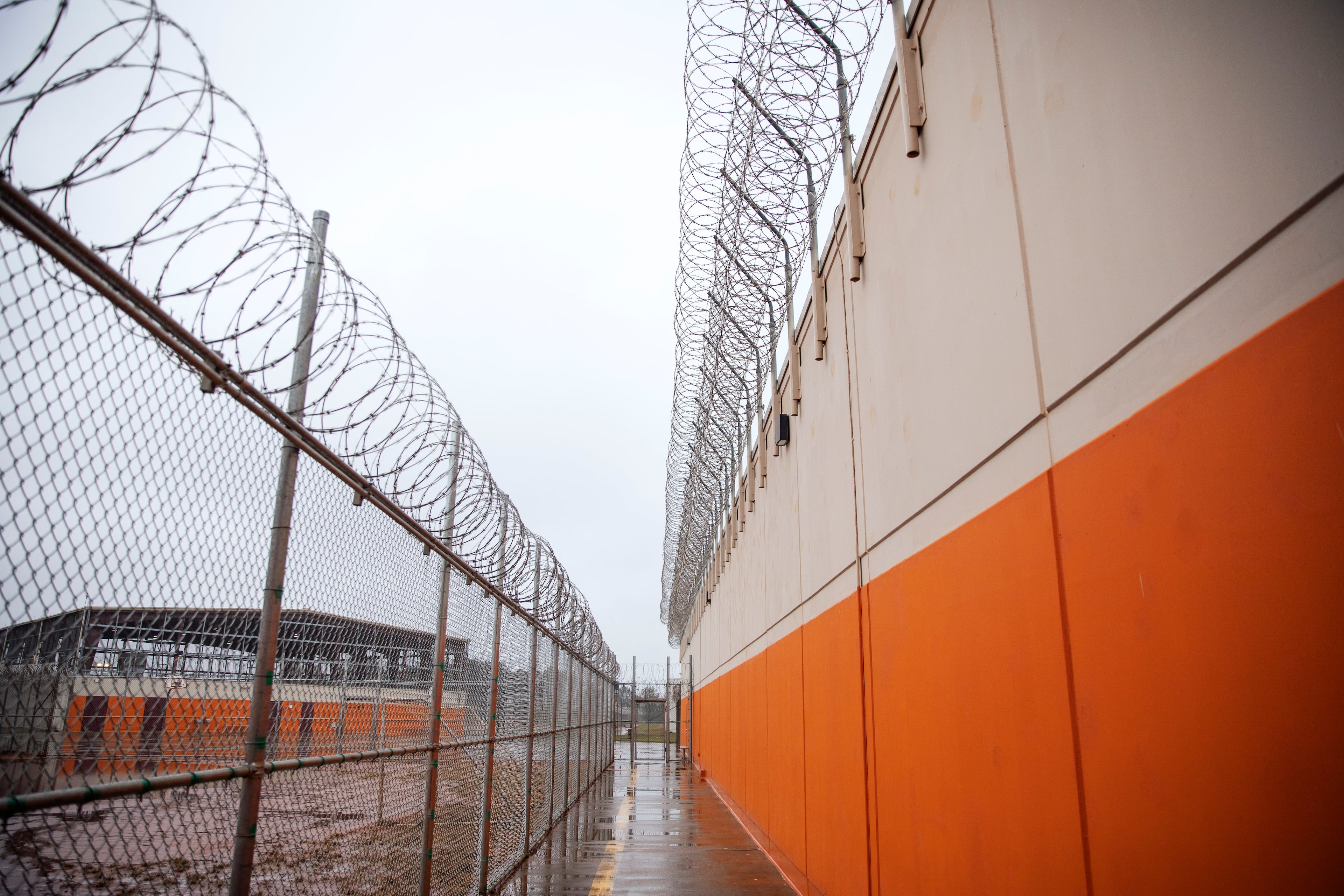 Barbed wire lines a recreation area at the Stewart Detention Center in Lumpkin, Georgia.