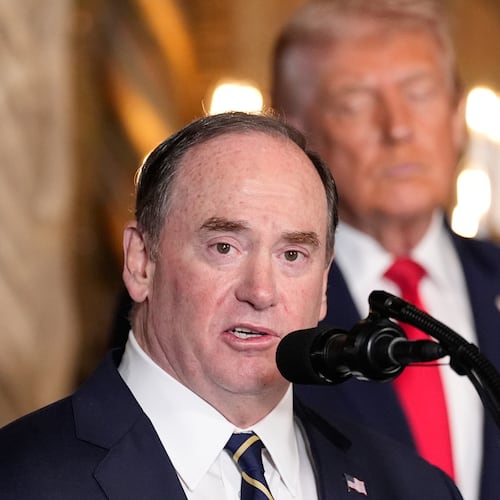 FILE - Secretary of the Navy John Phelan speaks, as President Donald Trump listens, at Trump's Mar-a-Lago club, Dec. 22, 2025, in Palm Beach, Fla. (AP Photo/Alex Brandon, file)