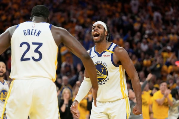 Golden State Warriors forward Draymond Green (23) celebrates with guard Buddy Hield (7) during the second half of Game 3 of an NBA basketball first-round playoff series against the Houston Rockets in San Francisco, Saturday, April 26, 2025. (AP Photo/Jeff Chiu)