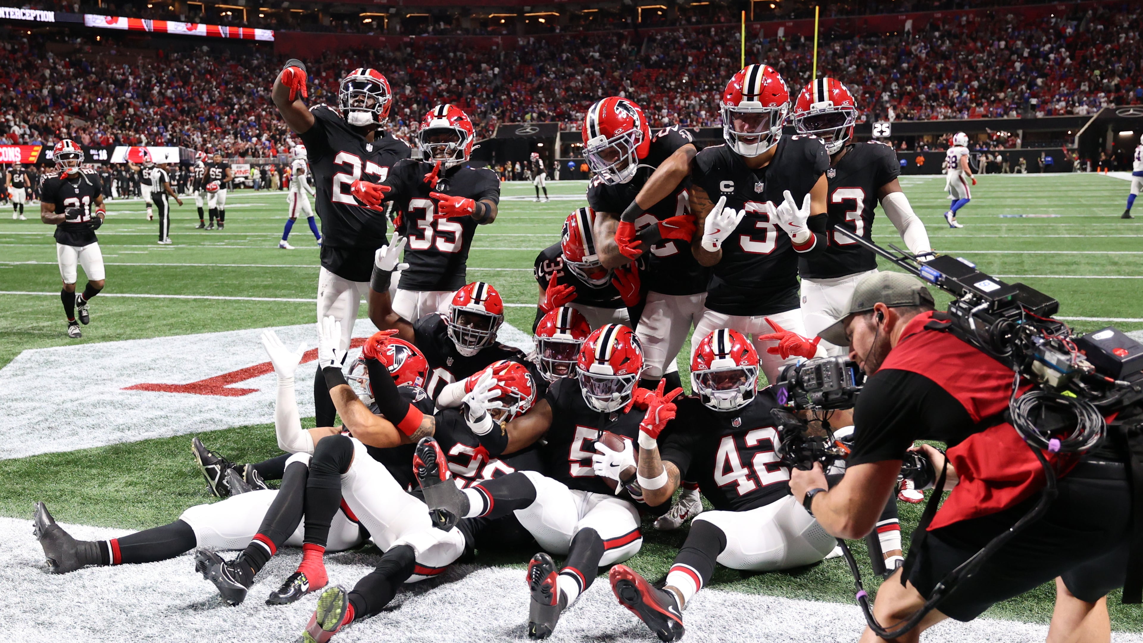 The Falcons celebrate DeAngelo Malone's interception late in the 24-14 win over the Bills on Monday, Oct. 13, 2025, in Atlanta. Dee Alford also had an interception for Atlanta, which held reigning NFL MVP Josh Allen to 180 yards passing. (Colin Hubbard/AP)