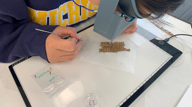 Papyrus Conservation Summer Seminar student Shijin (Giada) Jiang examines a papyrus fragment at the University of Michigan, Thursday, Aug. 6, 2026, in Ann Arbor, Mich. (AP Photo/Mike Householder)