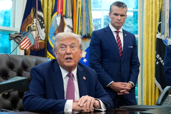 Defense Secretary Pete Hegseth (right) listened as President Donald Trump spoke at a White House event earlier this month.